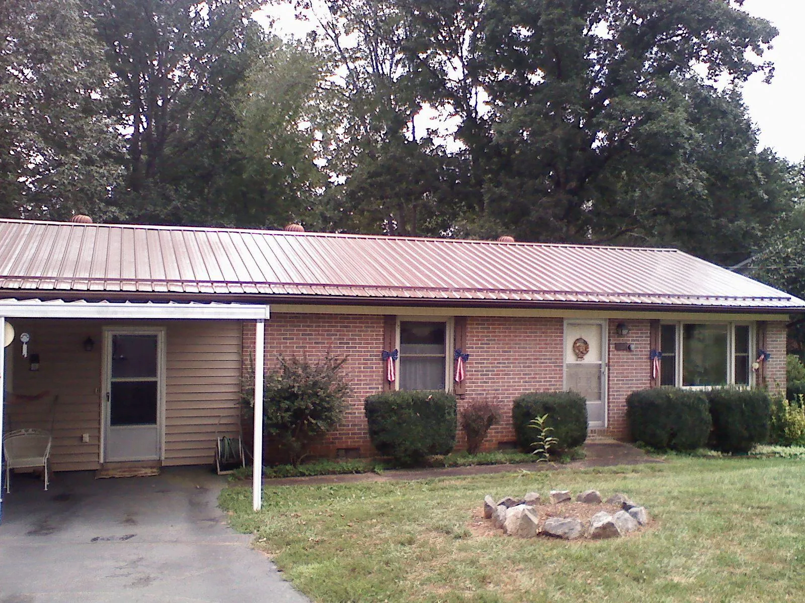 Bronze metal roof and carport on a brick ranch home — Roof Repair work by our crew in Boyertown