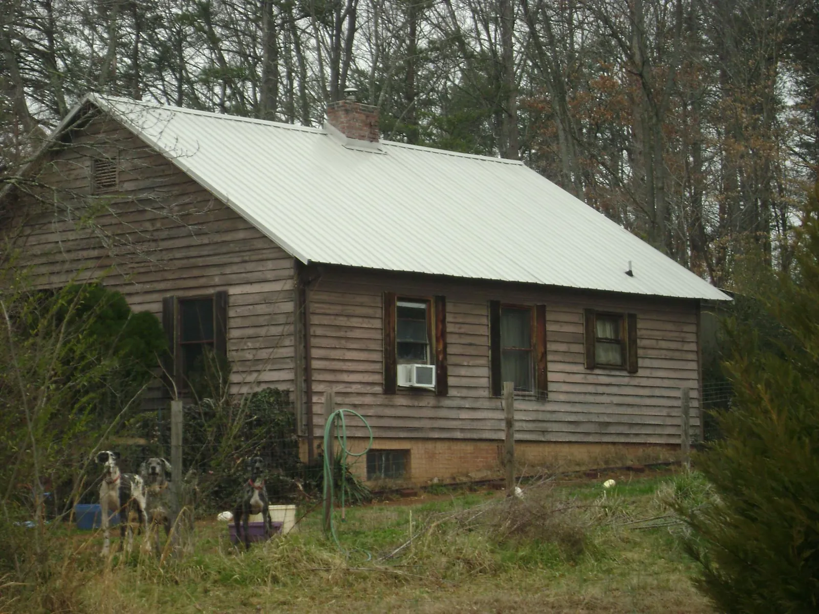 White metal roof on an old wood sided farmhouse, from a Metal Roof Installation job in Boyertown
